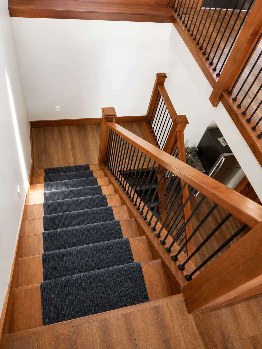 Custom wood staircase and black iron railing