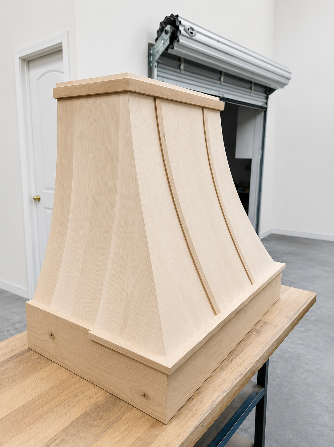 Handcrafted natural wood range hood in the Ott's shop